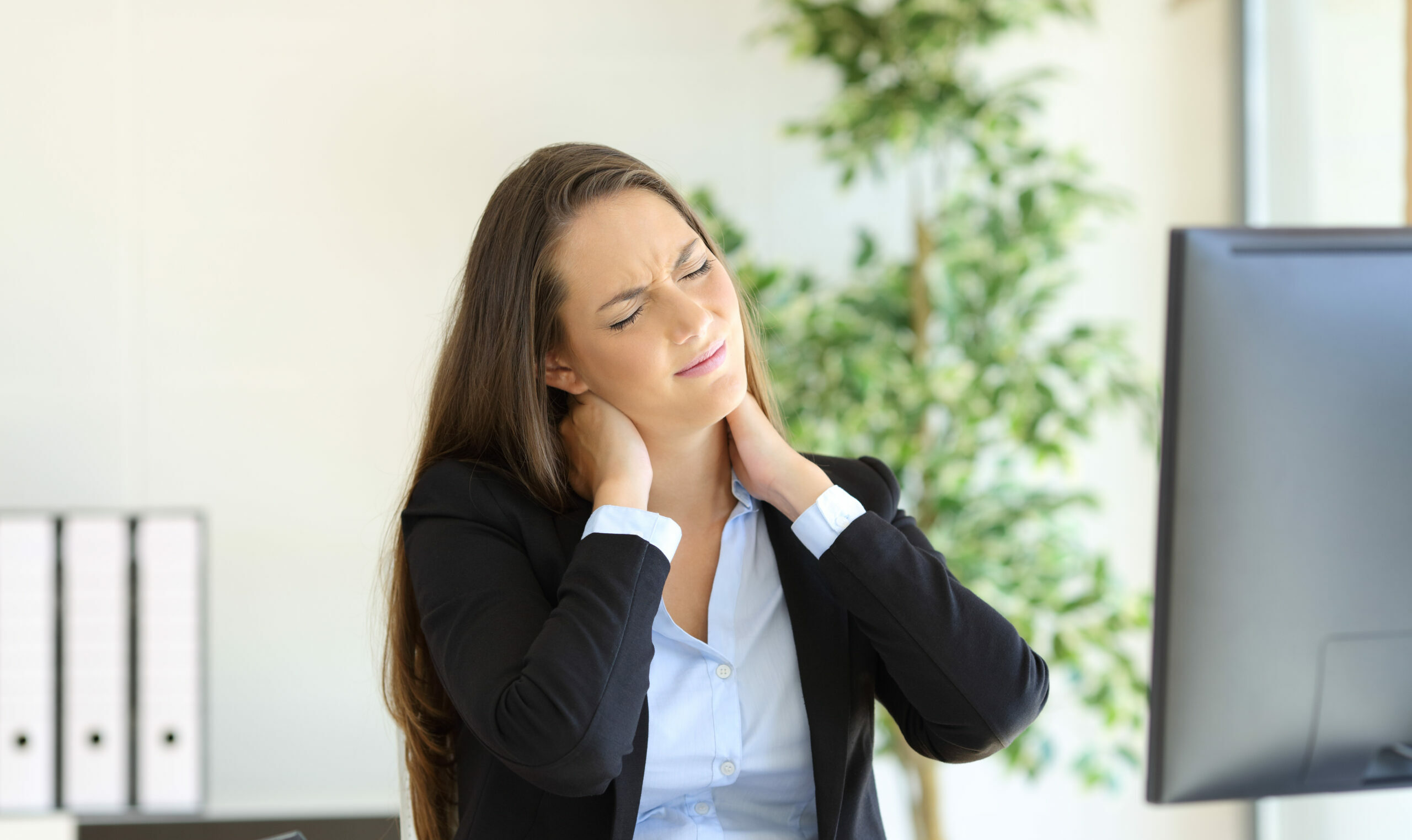 Businesswoman suffering neck pain