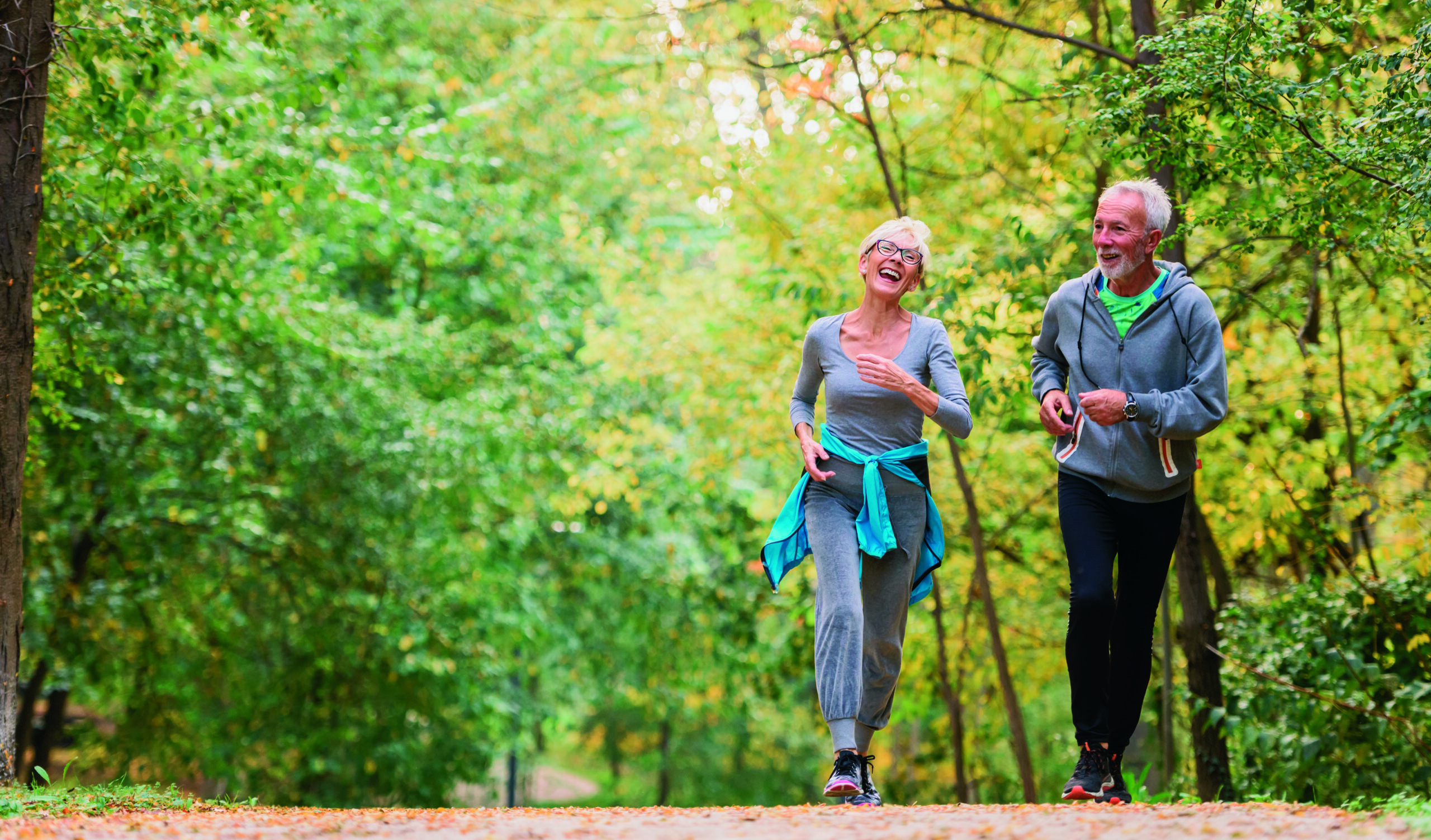 Cheerful,Active,Senior,Couple,Jogging,In,The,Park.,Exercise,Together